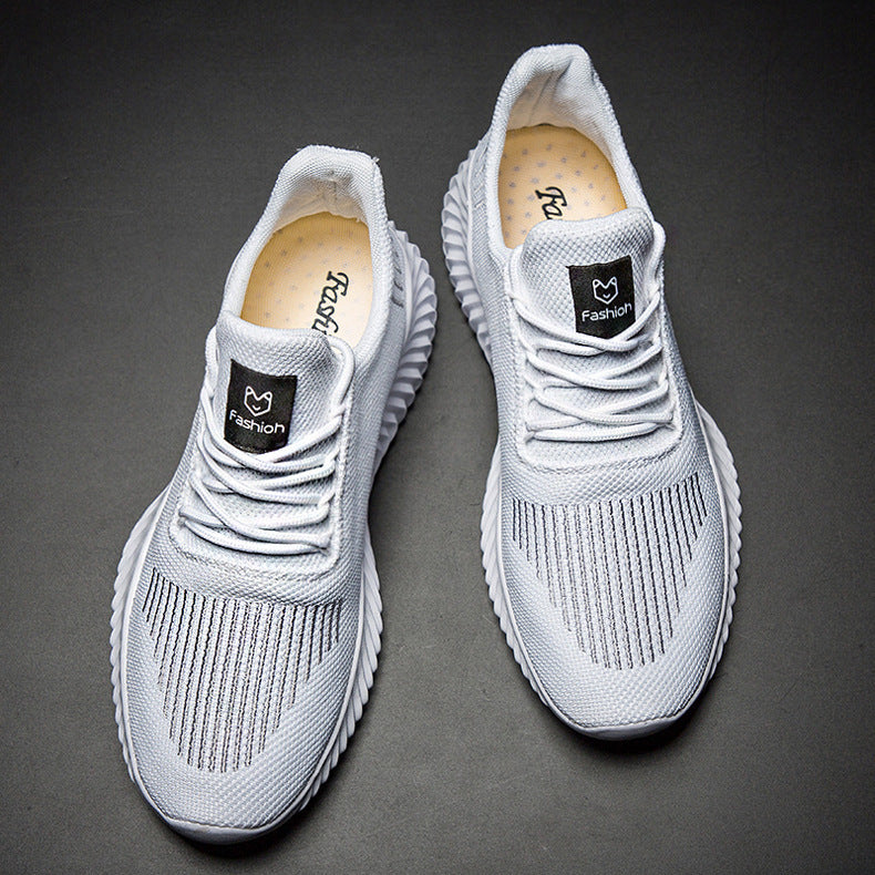 Pair of gray sneakers with brand logo on a dark background